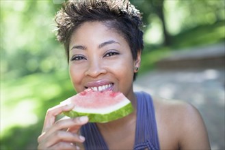 Black woman eating watermelon