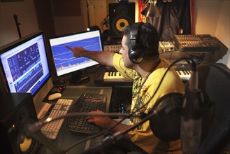 Caucasian man working in music studio