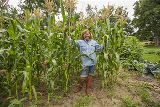 Older Caucasian woman standing in corn field on farm