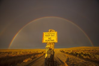 Warning sign in private fields under rainbow