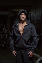 Caucasian athlete wearing hoody at night
