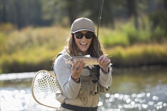 Caucasian woman displaying fishing catch