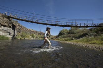 Caucasian woman fishing in rural river
