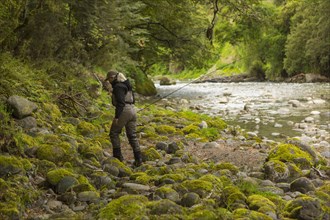 Caucasian woman walking in remote river