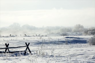 Fences in snowy rural landscape