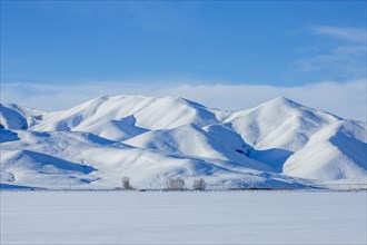 Snow covered hills in rural landscape