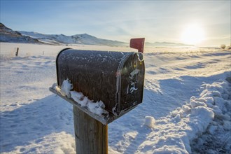 Mailbox in snowy rural field