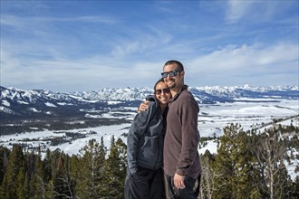 Caucasian couple smiling near remote landscape view