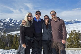 Caucasian family smiling near remote landscape view