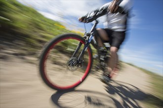 Blurred view of man riding mountain bike