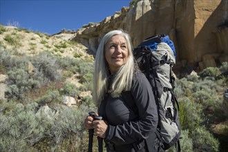 Older Caucasian woman hiking with backpack