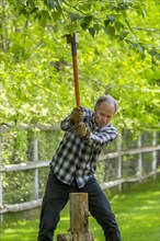 Caucasian man chopping wood