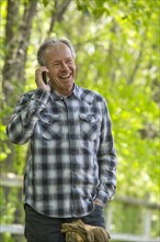 Caucasian man talking on cell phone outdoors