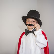 Caucasian magician twirling mustache