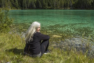 Caucasian woman sitting near river