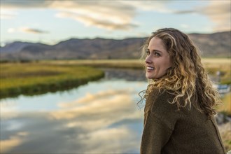 Caucasian woman smiling near mountain river