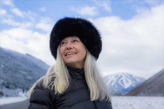 Caucasian woman wearing fur hat in winter