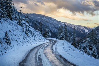 Snow on winding mountain road
