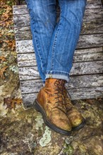 Legs of Caucasian woman wearing jeans and boots
