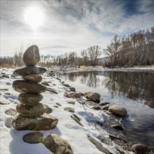 Pile of rocks balancing near river