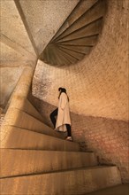 Caucasian woman climbing stone staircase