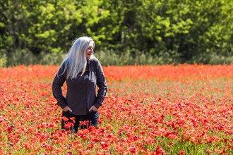 Caucasian woman looking away in field of flowers