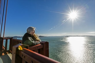 Caucasian woman admiring scenic view on bridge
