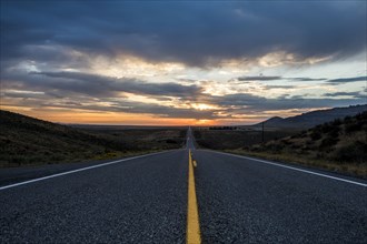 Empty remote road at sunset
