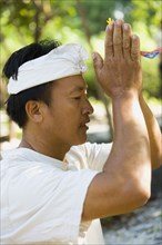Asian man praying