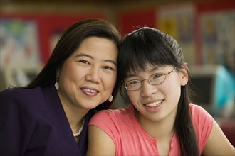 Asian teacher and student smiling