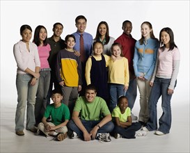 Multi-ethnic teacher and students posing