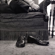 Man's shoes on floor in living room