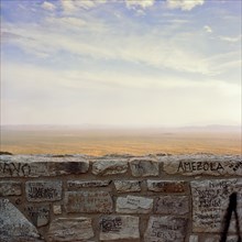 Graffiti on wall with desert in background