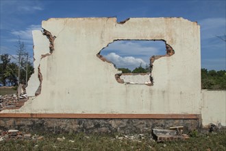 Walls of demolished house in rural field