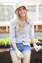 Smiling Caucasian woman in greenhouse