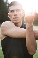 Hispanic man stretching before exercise