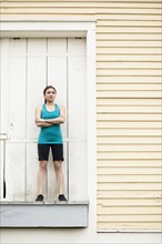 Asian woman in sportswear standing on loading dock