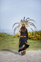 Native American woman wearing traditional headdress