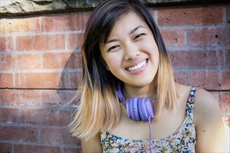 Portrait of smiling Chinese woman with headphones