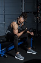 Mixed Race man lifting weights in gymnasium