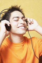 Hispanic man listening to headphones