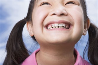 Close up of young Asian girl with orthodontics