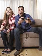 Hispanic couple playing video game