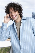 Hispanic male talking on cell phone