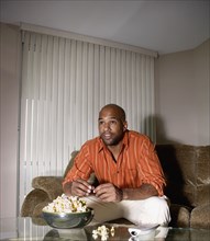Mixed Race man watching television