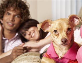 Multi-ethnic couple and small dog