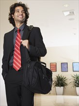 Hispanic businessman carrying bag