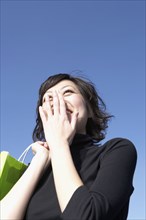 Low angle view of Asian woman laughing