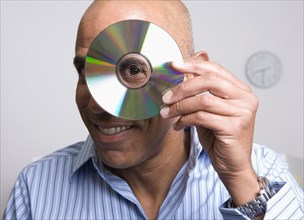 African businessman looking through middle of cd