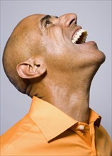 Portrait of African man laughing and looking up